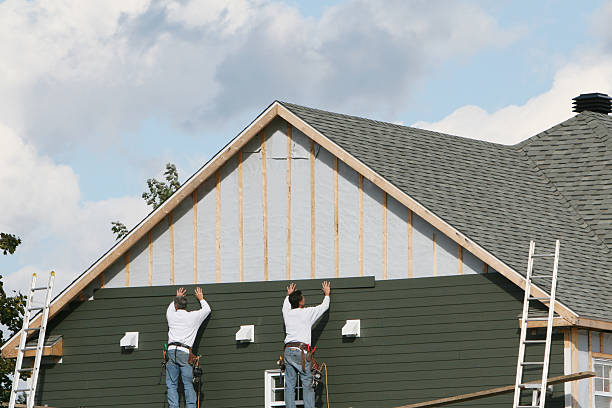 Professional Siding technician working in Champlain, VA
